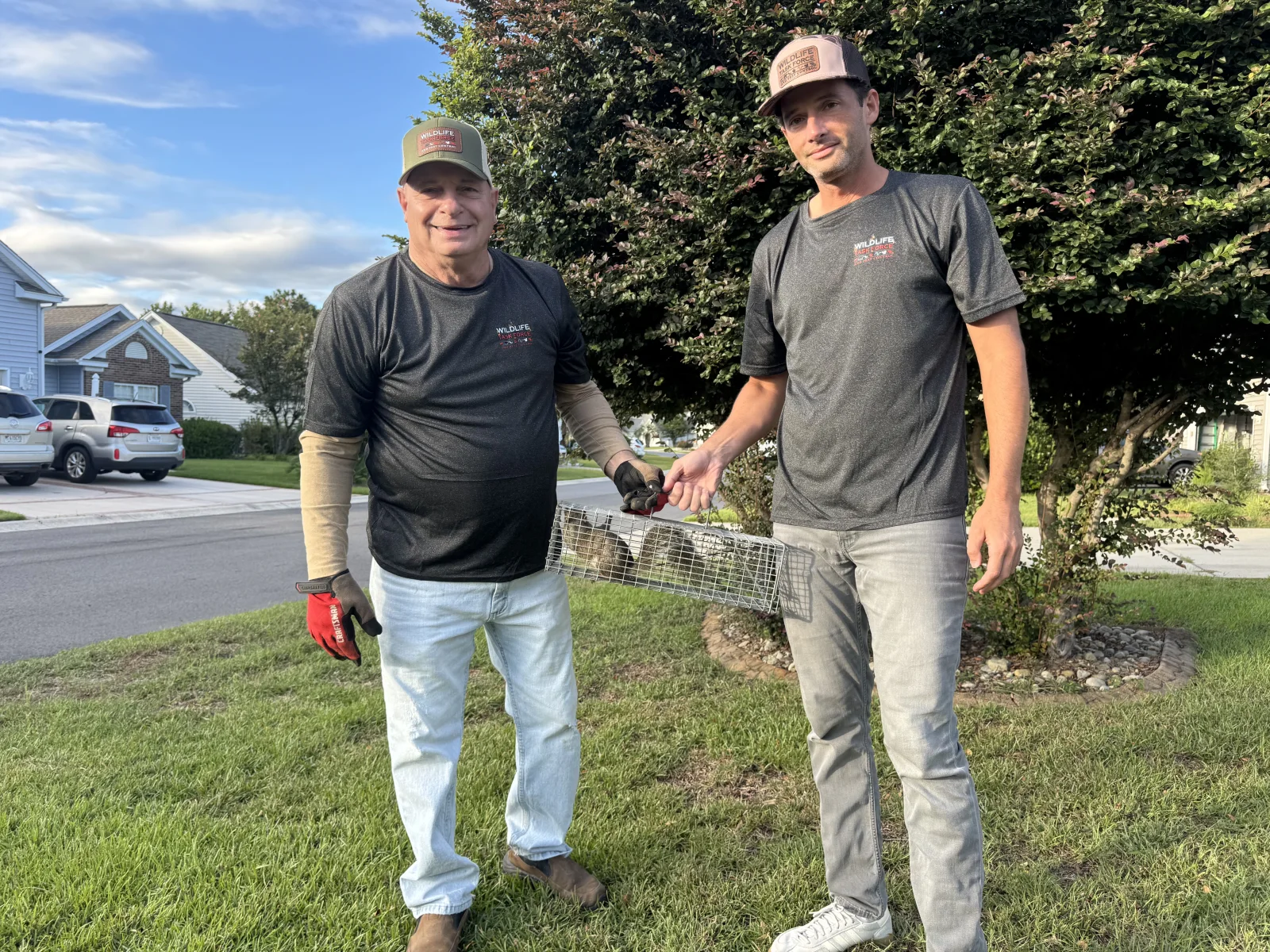 Wildlife Task Force technicians carrying field trapping equipment